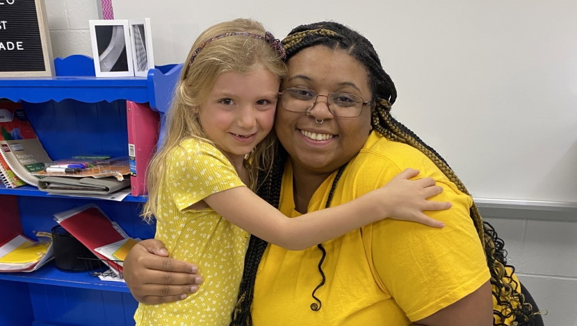 Intern and student pose of photo