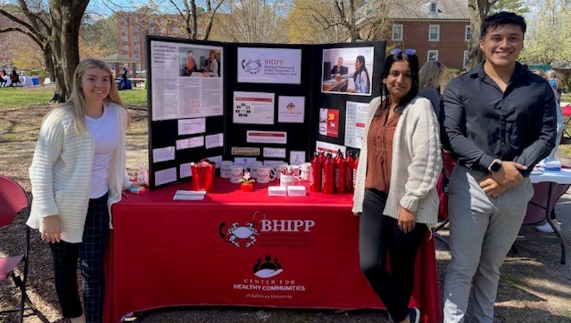 Behavioral Health Integration in Pediatric Primary Care (BHIPP) students at a program stand for the SU health fair