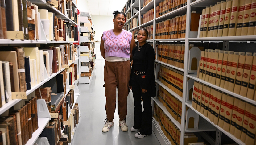 Two students pose in archives at Smithsonian